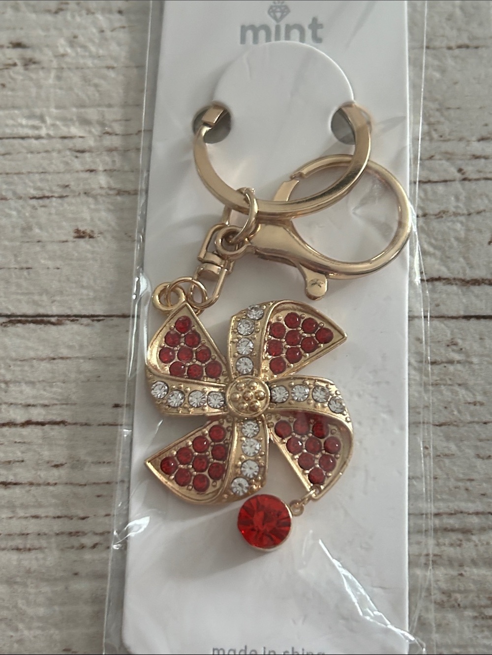 5/$25 Mint Gold-Tone Keychain with Red and Clear Crystal Flower
